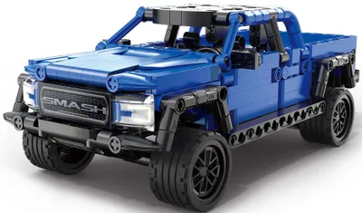 A blue toy truck made of building blocks, shown from a three-quarter front angle on a white background.