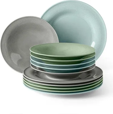 A stack of plates and bowls in various colors and sizes.