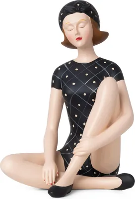 A decorative figurine of a woman in a vintage-style swimsuit and swim cap, sitting with her legs crossed.