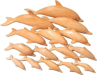 A collection of wooden dolphin figurines arranged in a cascading pattern.