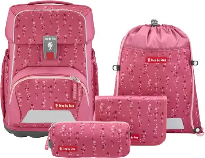 A set of four pink school bags with a polka dot pattern, displayed on a white background.