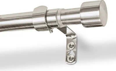 Close-up of a metal curtain rod with a bracket attached to a white wall.