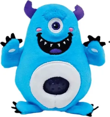 A blue plush monster toy with one eye, purple horns, and a wide smile.