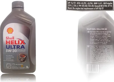 A bottle of Shell Helix Ultra 5W-30 motor oil is shown against a white and light gray background. Text and logos are visible on the bottle and on a separate label.