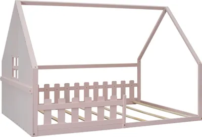 A pink house-shaped bed frame with a picket fence detail.