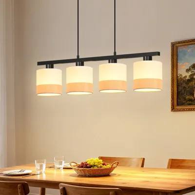 A dining table with a pendant light fixture above it.