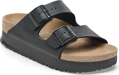 A black Birkenstock Arizona vegan platform sandal is shown from a slightly elevated side angle against a white background.