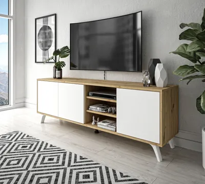 A modern living room with a TV stand, TV, and rug.