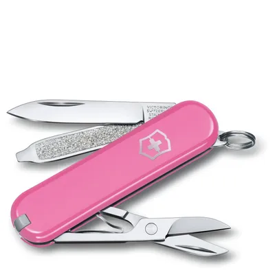 A pink Victorinox Swiss Army knife with its tools partially extended, set against a white background.