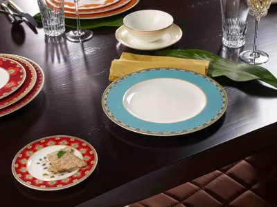 A dining table set with plates, bowls, and cutlery.