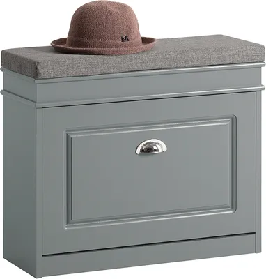 A gray shoe bench with a cushioned top and a single drawer with a silver handle. A brown hat sits on top of the bench.