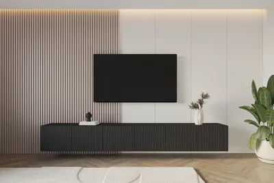 A modern living room with a wall-mounted TV and a black TV cabinet.