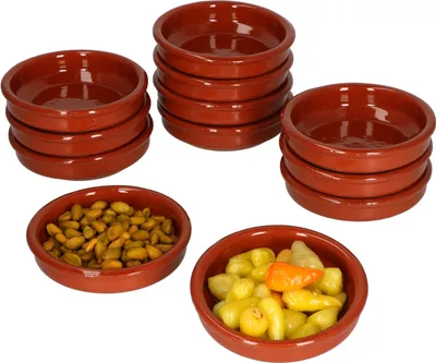 Several stacks of small, round, brown ceramic bowls, with two bowls filled with food items.