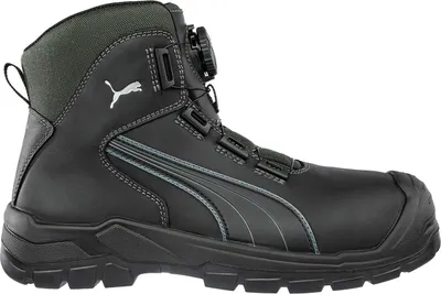 A side view of a black Puma safety boot with gray accents and a green collar.