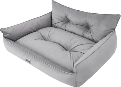 A gray dog bed with a tufted pillow.