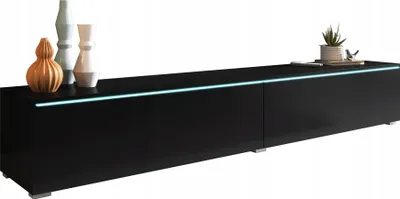 A modern black TV stand with decorative vases and a small plant on top.