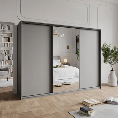 A bedroom scene with a large sliding door wardrobe.