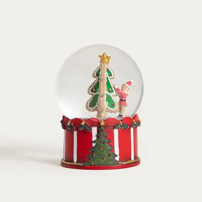 Produktbild von HOMLA LED-Schneekugel „RONIE“ mit Weihnachtsbaum auf gestreiftem Sockel, 10 x 13,5 cm