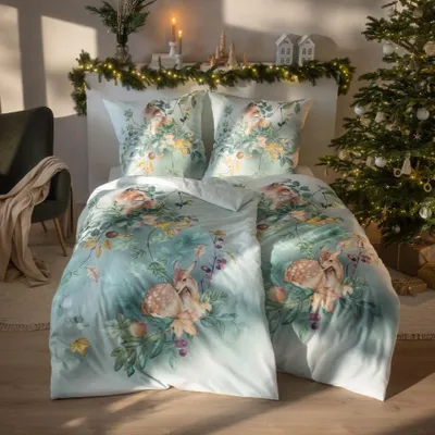 A bedroom scene decorated for Christmas, featuring a bed with festive bedding, a Christmas tree, and decorative lights.