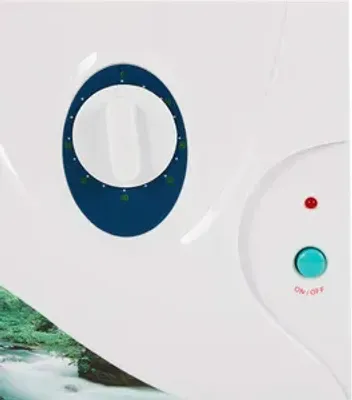 Close-up of a white electronic device with a blue dial timer and a teal on/off button.