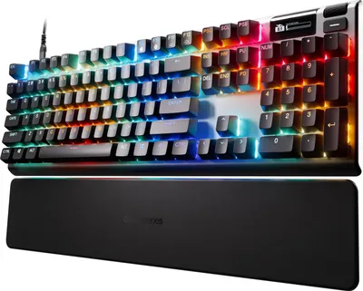 A SteelSeries Apex Pro Gen 3 keyboard with RGB lighting and a wrist rest.
