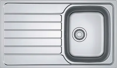 A top-down view of a stainless steel kitchen sink with a drainboard.