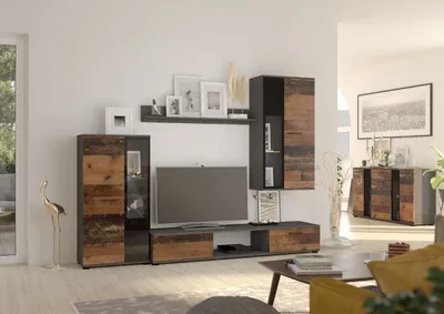 A modern living room with a TV unit, shelves, and a sideboard.