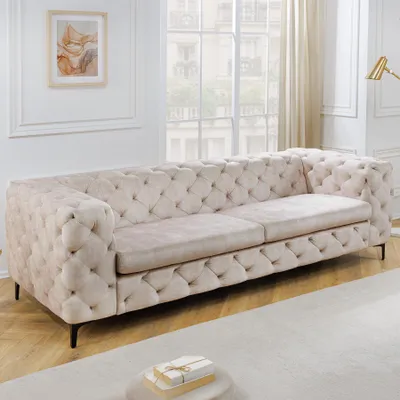 A tufted Chesterfield sofa in a living room setting.