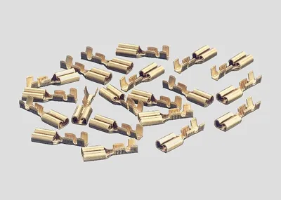 A pile of brass electrical connectors on a plain background.