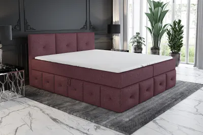 A bedroom scene featuring a violet boxspring bed with a white mattress and topper.