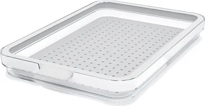 A clear, professional shot of a transparent refrigerator organizer with a gray perforated insert.