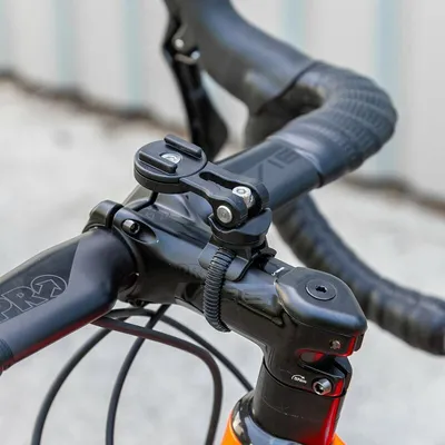 A close-up shot of a bicycle handlebar with a mount attached.