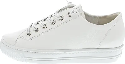 A side view of a white leather sneaker.
