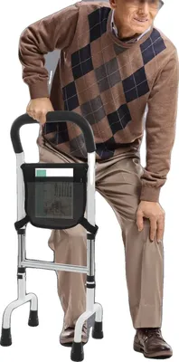 An elderly man is using a walker.