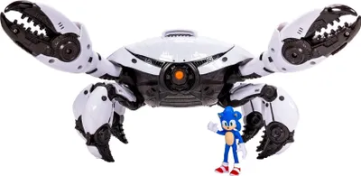 A toy crab-like robot with a small Sonic the Hedgehog figure in front of it, on a white background.