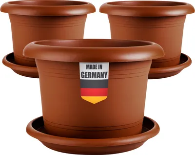 Three brown plastic plant pots with saucers are arranged in a studio setting against a white background. One pot in the foreground has a label indicating it is 'MADE IN GERMANY' with the German flag.
