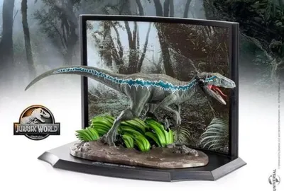 A Jurassic World collectible toy dinosaur, Blue, is displayed in a diorama with a jungle background and the Jurassic World logo.
