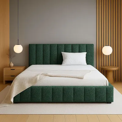 A bedroom scene with a green upholstered bed as the main focus.