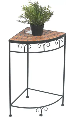 A corner plant stand with a mosaic top and a potted plant.