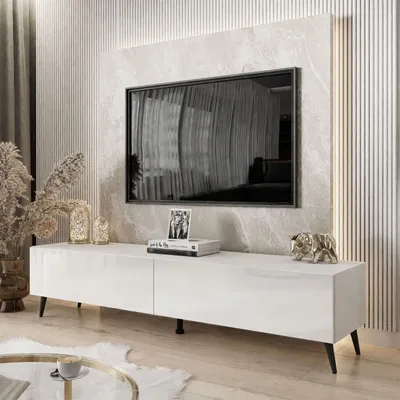 A modern living room with a white high-gloss TV stand featuring LED lighting, a large flat-screen TV, and decorative items.