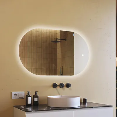 A modern bathroom vanity with a round sink, black faucets, and a large oval mirror with LED lighting.