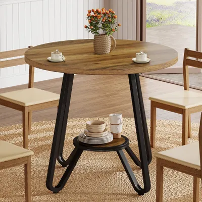 A round dining table with chairs in a dining room setting.