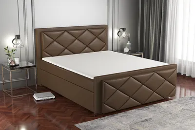 A brown boxspring bed with a white mattress is shown in a bedroom setting.
