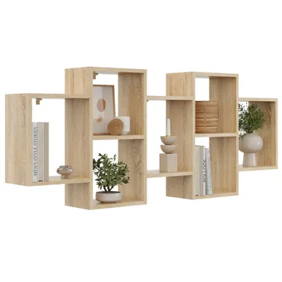 A wooden wall shelf with multiple compartments, decorated with books, a plant, and decorative items.
