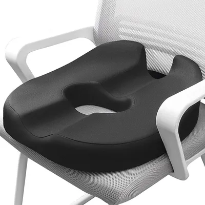 A black ergonomic seat cushion on a white and gray chair.
