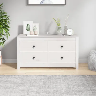A white wooden dresser with four drawers is shown in a room with a light gray wall and a light gray rug.