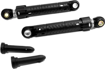 Two black shock absorbers and two black plastic pegs are laid out on a white background.