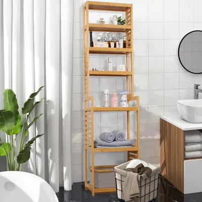 A bamboo shelf unit filled with bathroom accessories and towels, placed next to a sink and a plant.