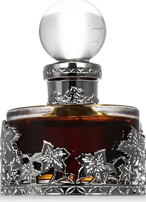 A close-up studio shot of a perfume bottle with ornate silver detailing.