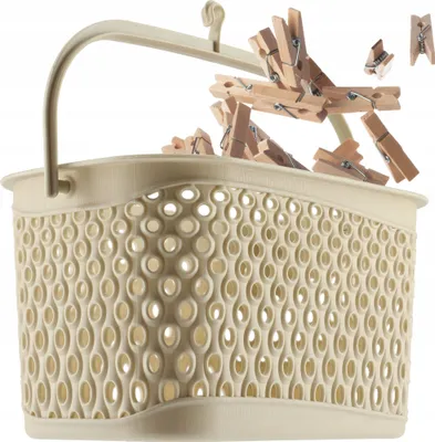 A beige laundry basket filled with wooden clothespins, with some clothespins spilling out.